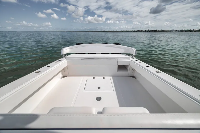 Slide: The Image of 2016 Bahama 41 boat interior with open deck, surrounded by calm waters. - 18