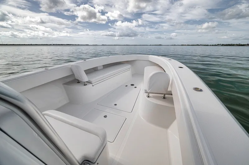 Slide: The Image of 2016 Bahama 41 boat interior with seating, calm waters, and cloudy sky. - 29