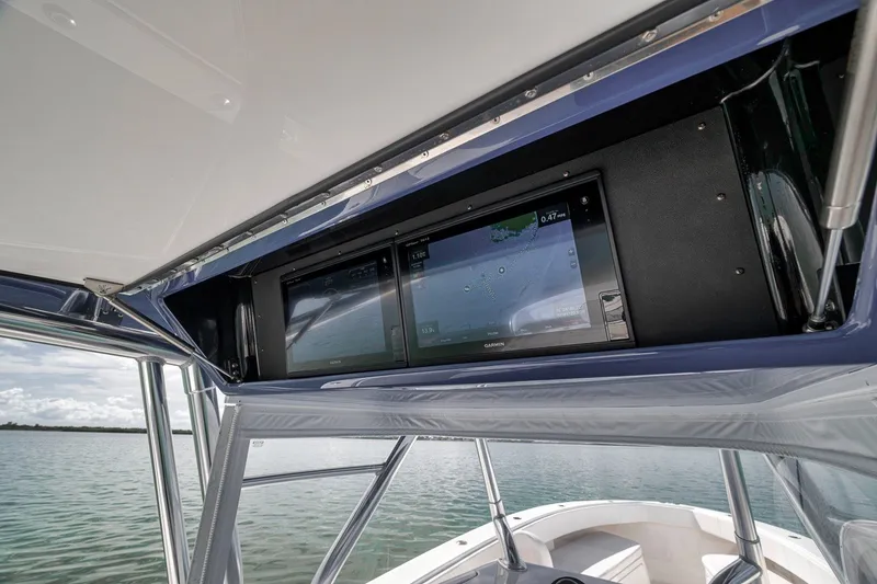 Slide: The Image of 2016 Bahama 41 boat with advanced navigation system, featuring dual Garmin displays. - 10