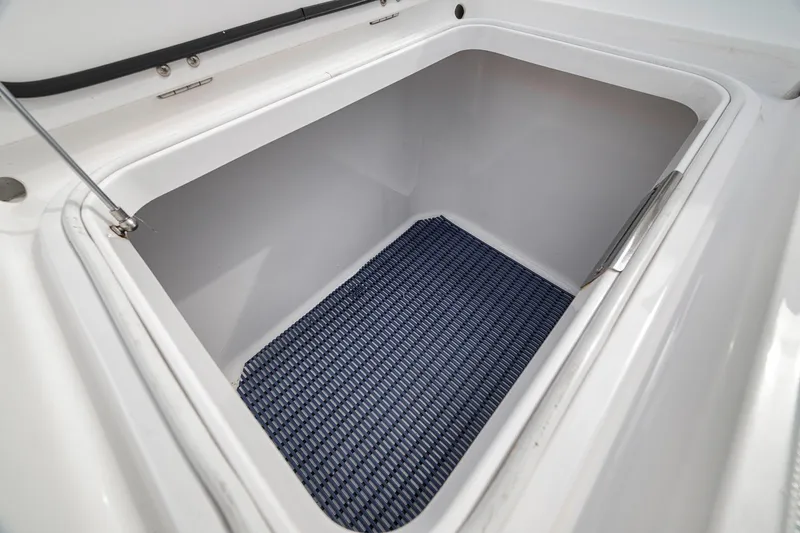 Slide: The Image of Open storage compartment on a 2016 Bahama 41 boat with blue mat inside. - 32