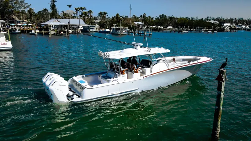 Slide: The Image of 2026 Mag Bay 43 CC boat cruising in a scenic marina setting. - 0