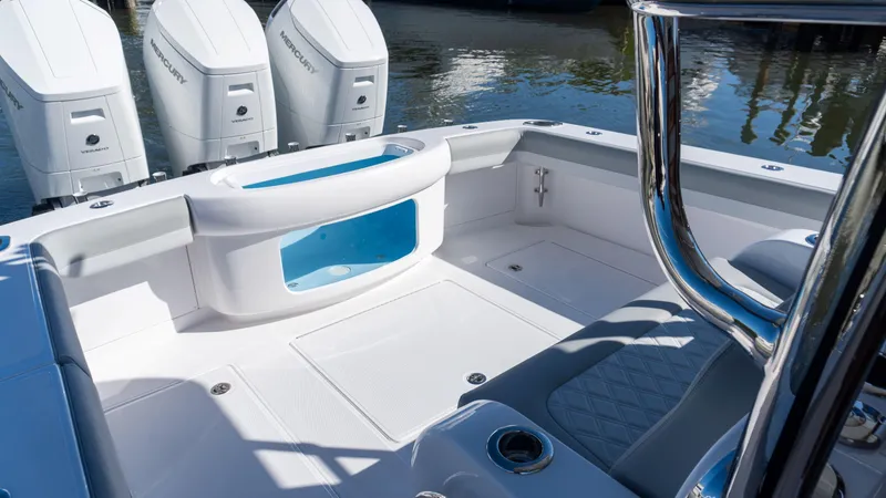 Slide: The Image of 2026 Mag Bay 43 CC boat interior with triple outboard engines and spacious deck. - 14