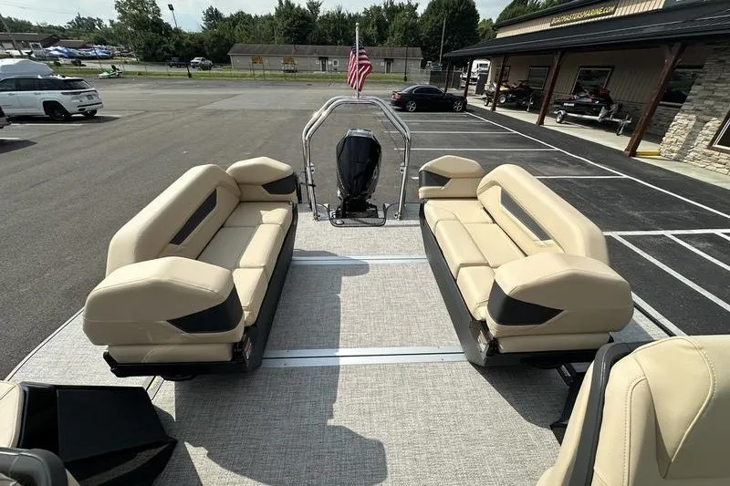 Slide: The Image of 2026 Flamingo Rove 24' pontoon boat with beige seating, parked in a lot. - 39