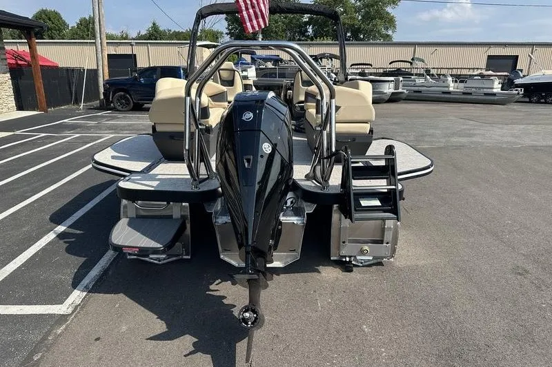 Slide: The Image of 2026 Flamingo Rove 24' boat with outboard motor, parked in a marina. - 26