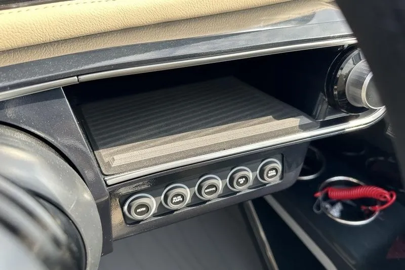 Slide: The Image of Dashboard of a 2026 Flamingo Rove 24' with control buttons and storage compartment. - 20