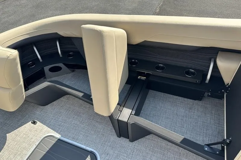Slide: The Image of Interior seating of 2026 Flamingo Rove 24' boat with beige upholstery and cup holders. - 22