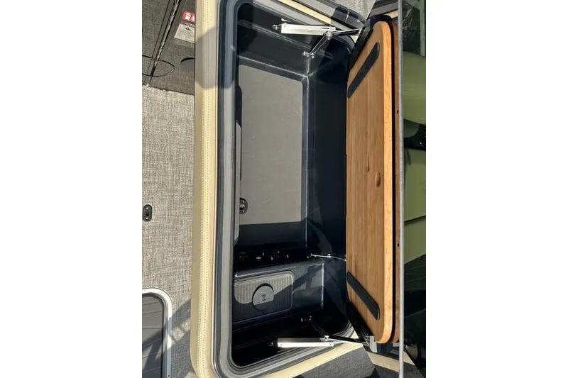Slide: The Image of Open storage compartment in 2026 Flamingo Rove 24' RV with wooden lid. - 42