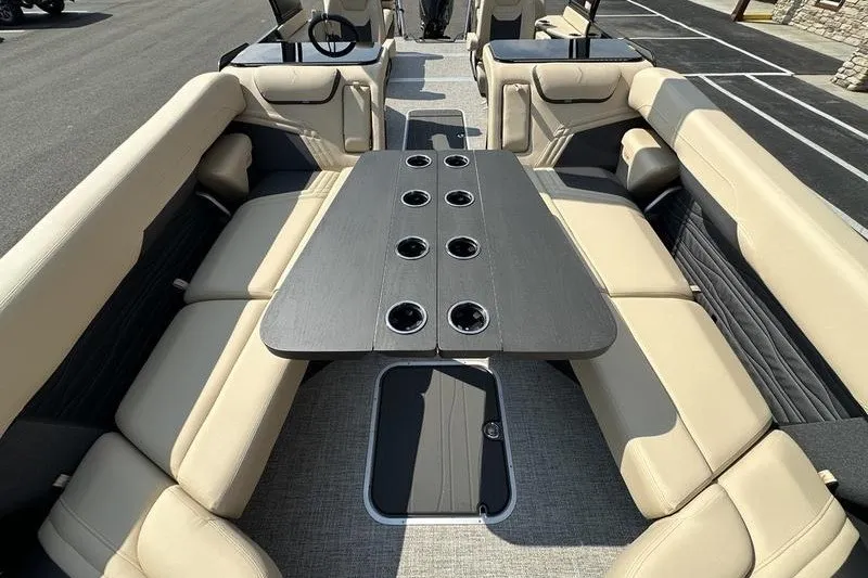 Slide: The Image of Luxurious interior of 2026 Flamingo Rove 24' boat with beige seating and central table. - 48
