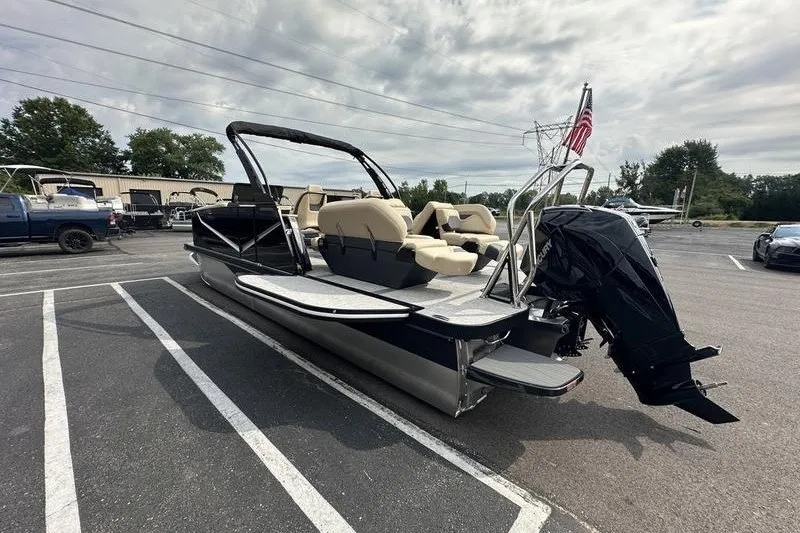 Slide: The Image of 2026 Flamingo Rove 24' pontoon boat with seating, parked outdoors under cloudy sky. - 40
