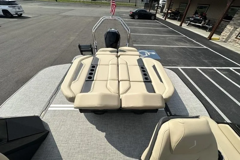 Slide: The Image of 2026 Flamingo Rove 24' boat with beige seating, parked in a lot. - 37