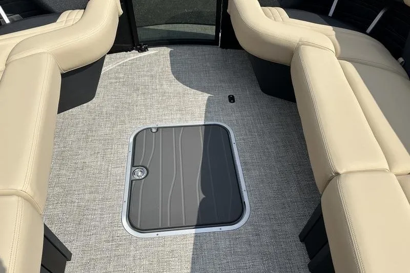 Slide: The Image of Interior of 2026 Flamingo Rove 24' boat with beige seating and floor hatch. - 13