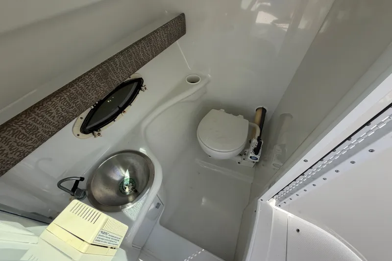 Slide: The Image of 2004 Formula 260 Bowrider boat bathroom with sink and toilet. - 15