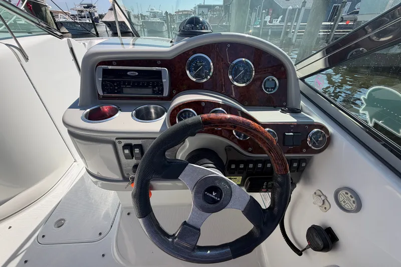 Slide: The Image of Steering console of a 2004 Formula 260 Bowrider boat with gauges and controls. - 16