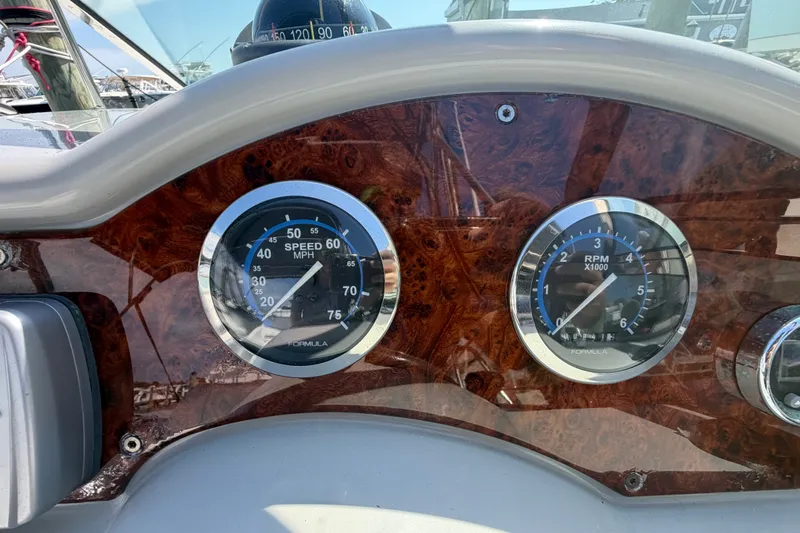 Slide: The Image of Dashboard of a 2004 Formula 260 Bowrider showing speedometer and RPM gauges. - 20