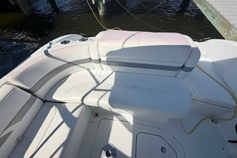 Slide: The Image of 2004 Formula 260 Bowrider boat interior with white seating and cup holders. - 25