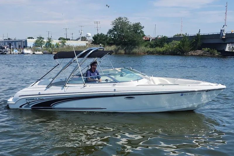 The Image of 2004 Formula 260 Bowrider boat cruising on a calm river under a clear sky. - 0