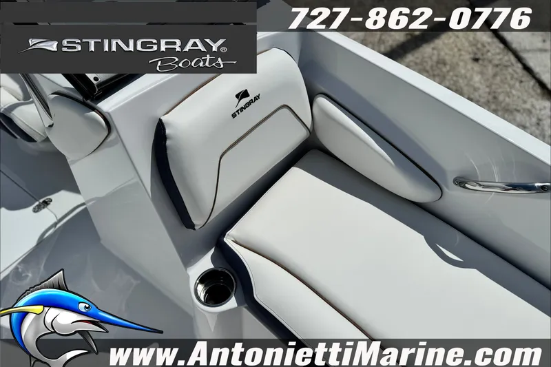 Slide: The Image of Stingray 19 DC 2027 boat interior with white seating, logo, and contact details. - 16