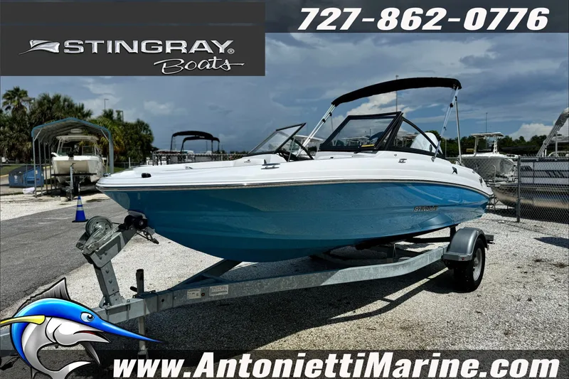 Slide: The Image of 2027 Stingray 19 DC boat on trailer at Antonietti Marine dealership. - 3