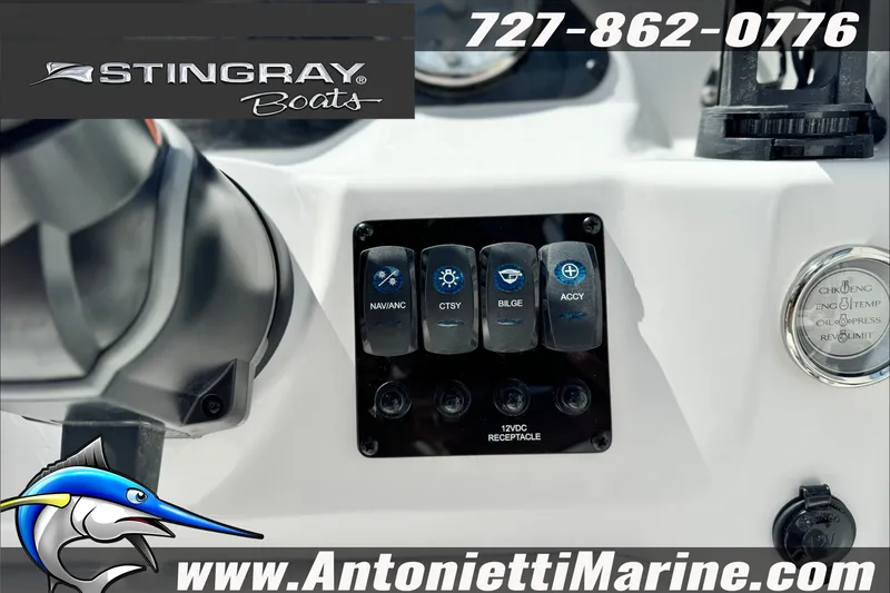 Slide: The Image of Control panel of a 2027 Stingray 19 DC boat with switches and gauges. - 25