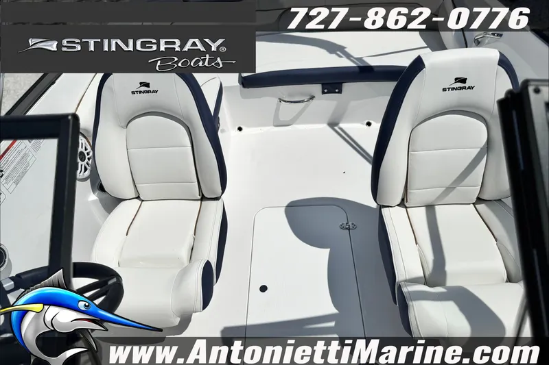 Slide: The Image of Interior view of 2027 Stingray 19 DC boat with white seating and branding. - 28