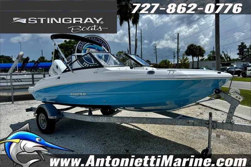 Slide: The Image of 2027 Stingray 19 DC boat on trailer at Antonietti Marine dealership. - 5