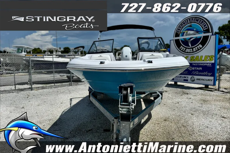 Slide: The Image of 2027 Stingray 19 DC boat on trailer at Antonietti Marine dealership. - 4
