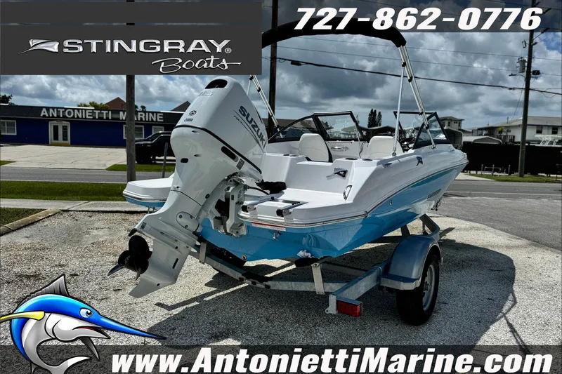 Slide: The Image of 2027 Stingray 19 DC boat on trailer at Antonietti Marine dealership. - 7