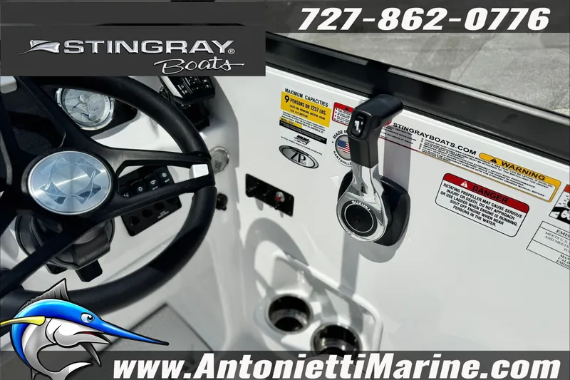 Slide: The Image of 2027 Stingray 19 DC boat dashboard with controls and branding details. - 27