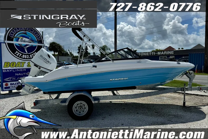 Slide: The Image of 2027 Stingray 19 DC boat on trailer at Antonietti Marine dealership. - 6