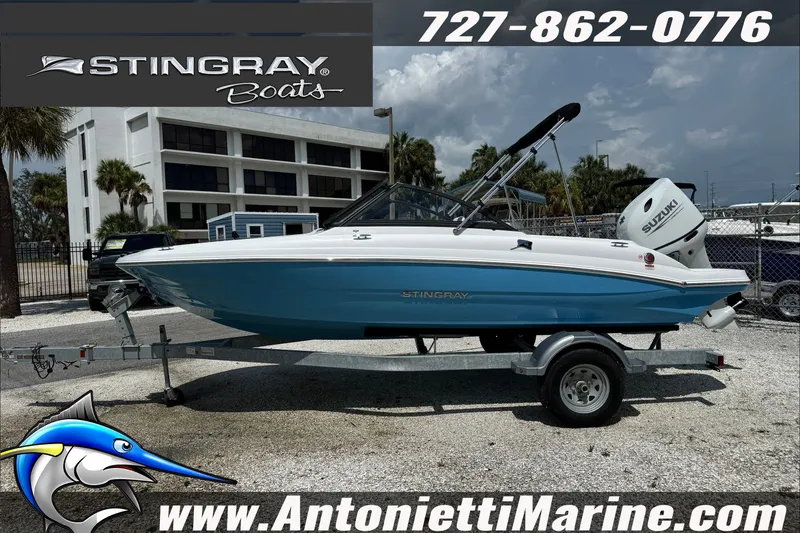 Slide: The Image of 2027 Stingray 19 DC boat on trailer, displayed at Antonietti Marine dealership. - 2