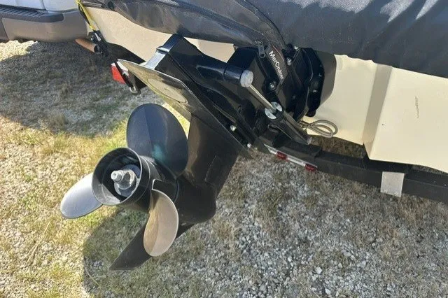 Slide: The Image of 2018 Sea Ray SPX 190 boat propeller and outdrive on gravel surface. - 19