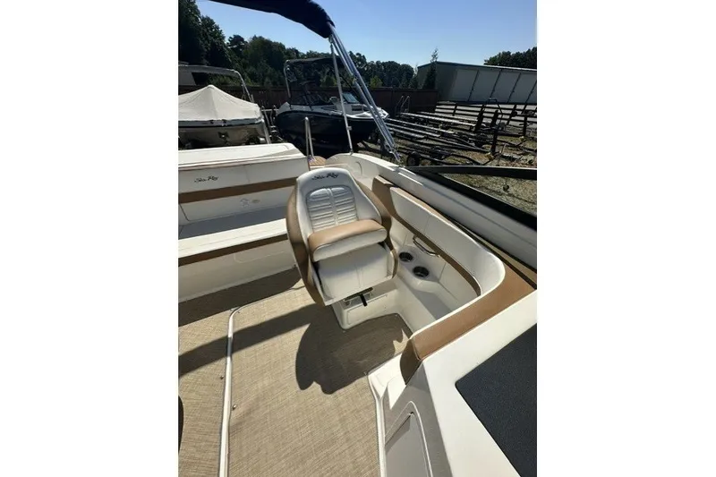 Slide: The Image of 2018 Sea Ray SPX 190 boat interior with beige seating and cup holders. - 26