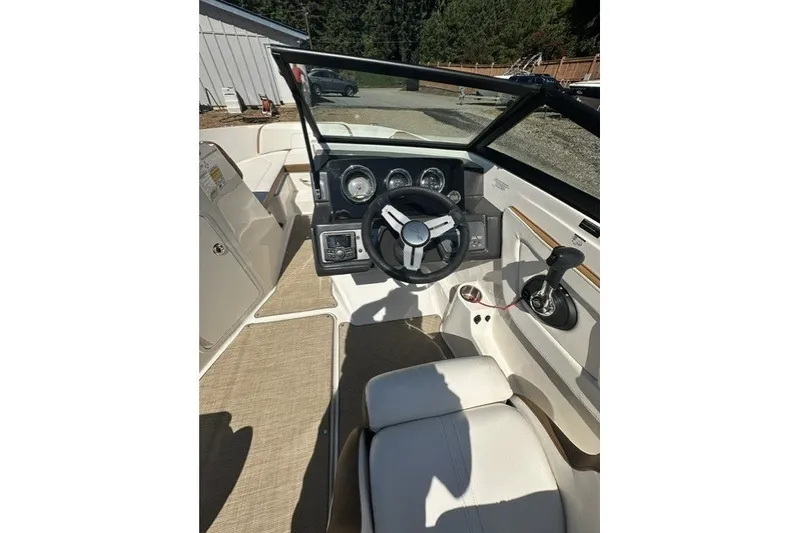 Slide: The Image of 2018 Sea Ray SPX 190 boat interior with steering wheel and control panel. - 24