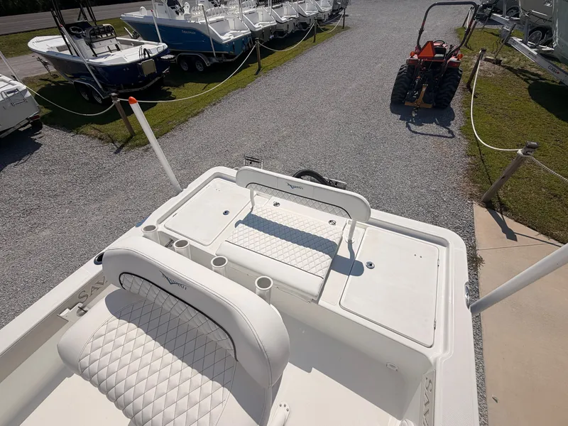 Slide: The Image of The image shows the stern of a Savannah 220 IS boat with cushioned seats and cup holders. - 16