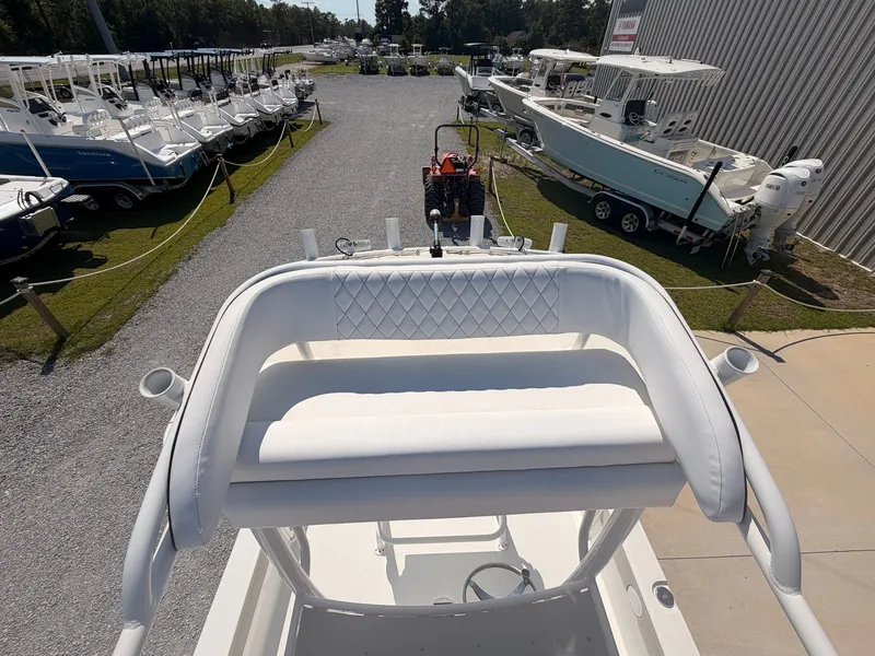 Slide: The Image of A 2027 Savannah 220 IS boat is parked in a boatyard alongside other boats. - 15
