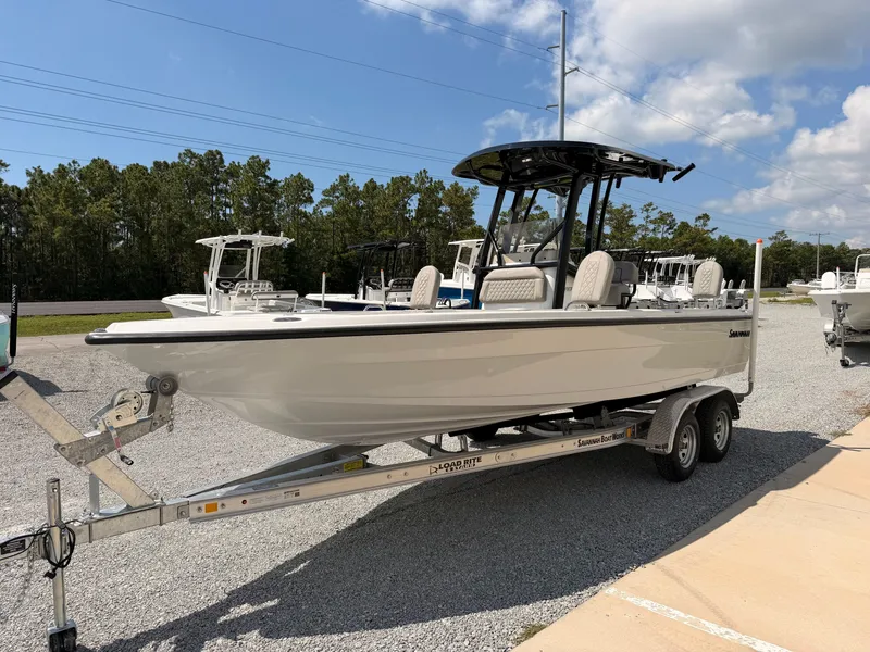 Slide: The Image of A 2027 Savannah 210X boat on a trailer, surrounded by other boats and trees. - 5