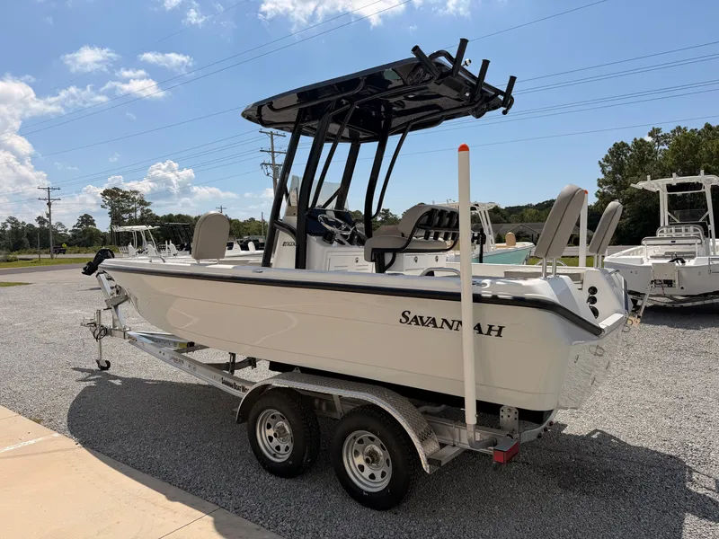Slide: The Image of A 2027 Savannah 210X boat on a trailer in a gravel lot. - 3