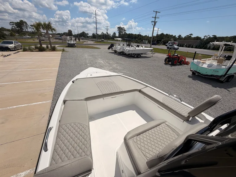 Slide: The Image of The image shows a 2027 Savannah 210X boat with cushioned seating and an open deck. - 9