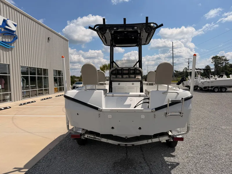 Slide: The Image of A 2027 Savannah 210X boat on a trailer in front of a building. - 2