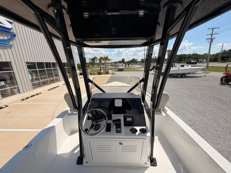 Slide: The Image of The image shows the cockpit of a 2027 Savannah 210X boat with steering and instruments. - 8