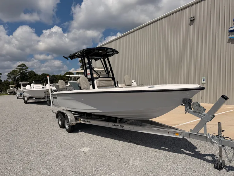 Slide: The Image of A 2027 Savannah 210X boat on a trailer in front of a large building. - 7