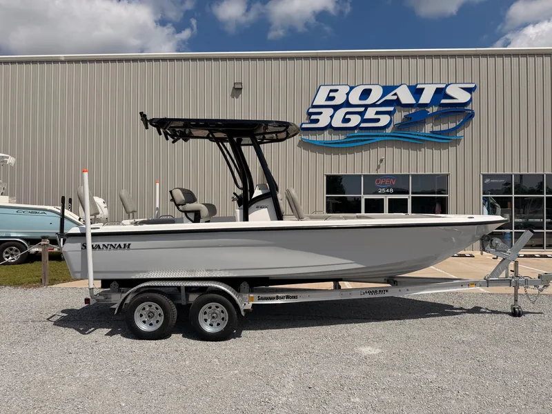 The Image of A 2027 Savannah 210X boat on a trailer in front of a boat dealership. - 0
