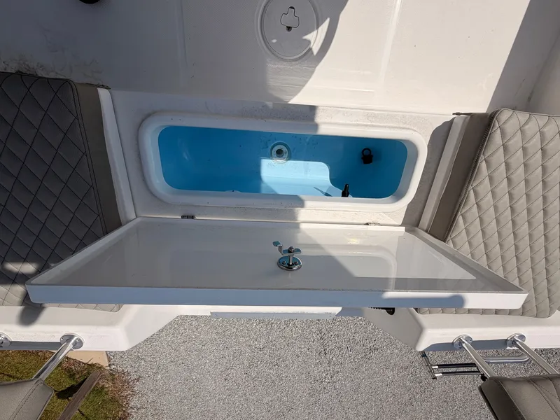 Slide: The Image of The image shows the cockpit of a Savannah 210X boat with a blue storage compartment. - 14