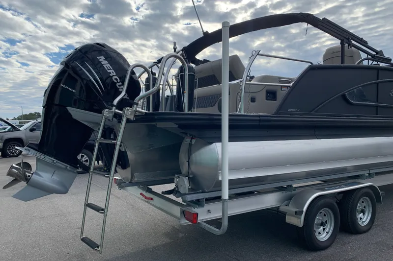 Slide: The Image of 2022 Barletta LUSSO 25U pontoon boat with Mercury Verado engine on trailer. - 3