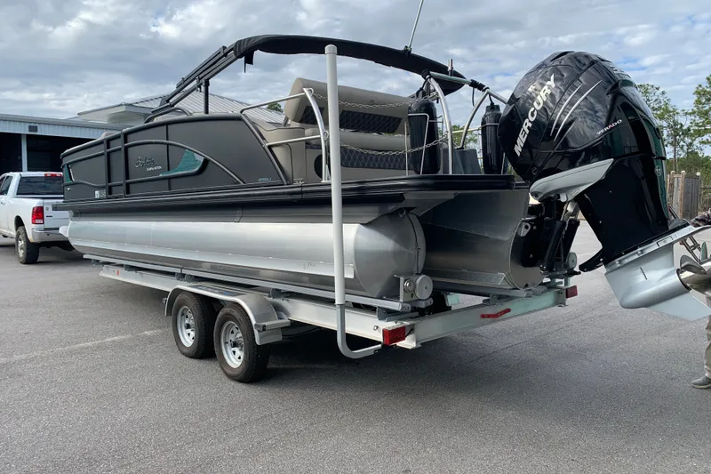 Slide: The Image of 2022 Barletta LUSSO 25U pontoon boat on trailer with Mercury outboard engine. - 5