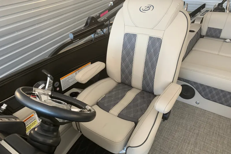 Slide: The Image of Luxurious 2022 Barletta LUSSO 25U boat interior with plush captain's chair and steering wheel. - 12