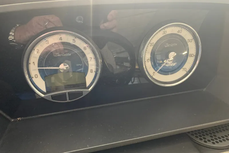 Slide: The Image of Dashboard gauges of a 2022 Barletta LUSSO 25U, displaying RPM and speed. - 25