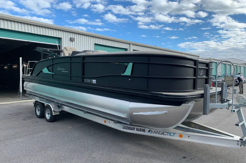 The Image of 2022 Barletta LUSSO 25U pontoon boat on trailer, parked outside storage facility. - 0