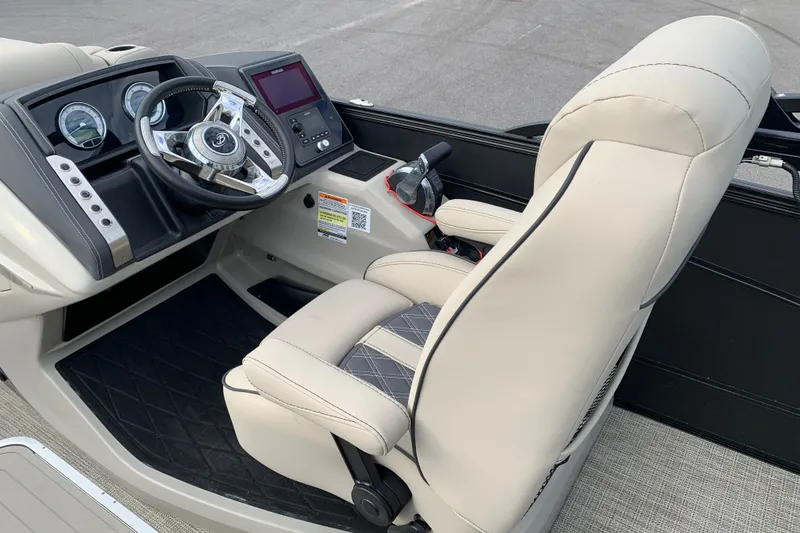 Slide: The Image of Luxurious 2022 Barletta LUSSO 25U boat cockpit with plush seating and modern dashboard. - 32