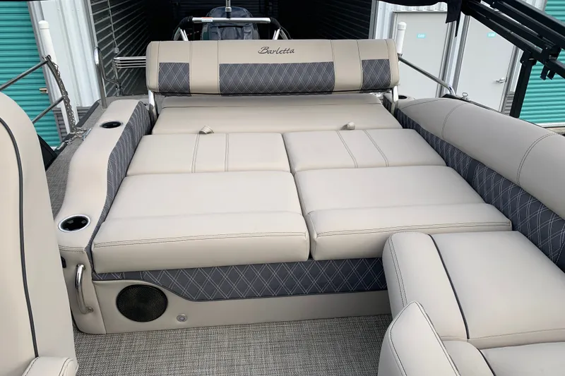 Slide: The Image of 2022 Barletta LUSSO 25U boat interior with luxurious beige seating and cup holders. - 29